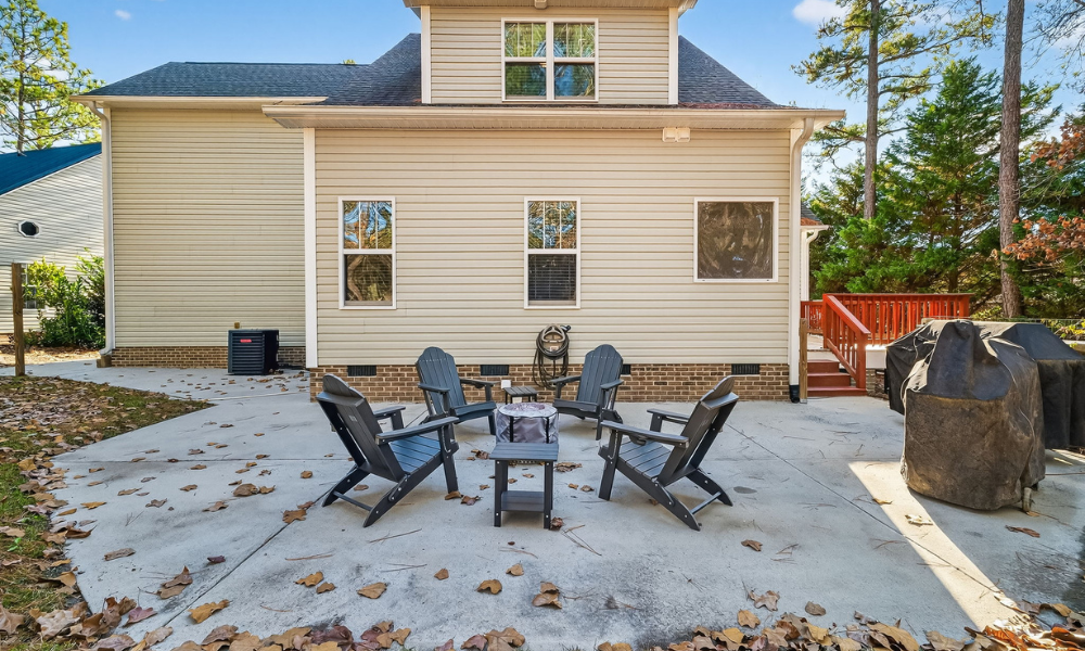 Backyard of 124 Riviera Ln Sanford NC with deck, bonfire pit, and two grills, listed by Brycen Erdody, Torch & Trail Realty